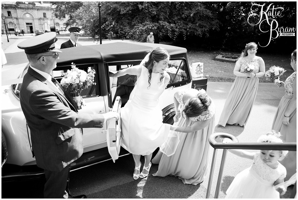 black and white wedding photo, bride getting out of the car, the arches dean clough, yorkshire wedding venue, halifax wedding venue, saltaire wedding, saltaire church, yorkshire wedding photographer